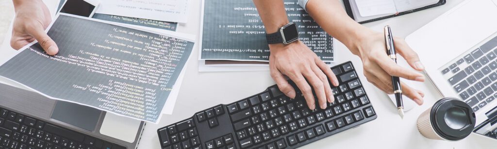 A person is typing on the keyboard of a computer.