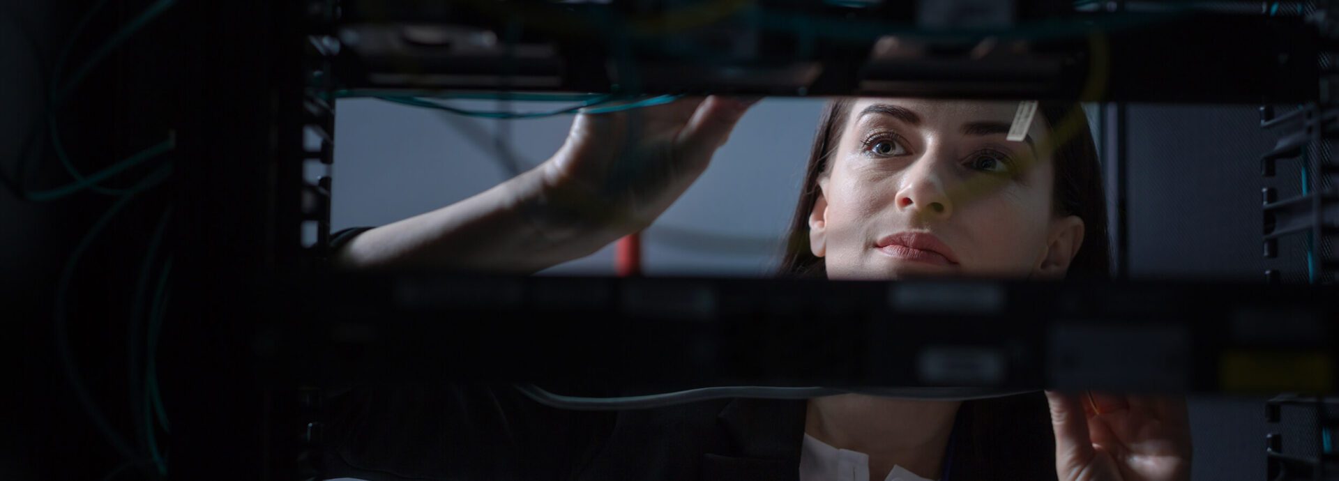 A woman looking at her reflection in the mirror.